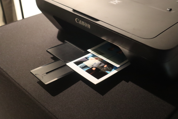 A printer automatically prints a photo.