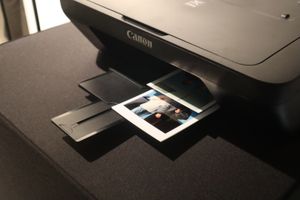 A printer automatically prints a photo.